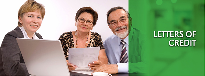 A team of smiling bank lenders help you prepare business documents for a letter of credit.